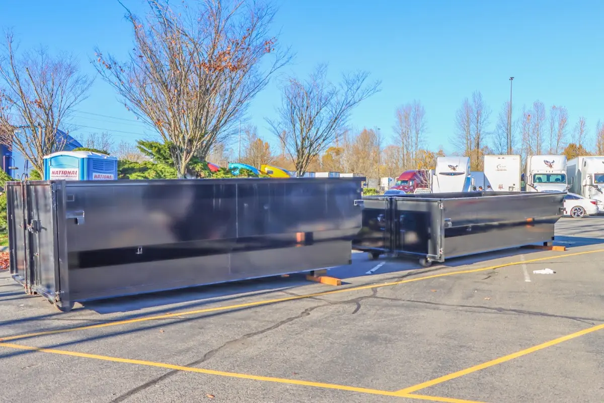 Professional dumpster rental service with roll-off container on residential driveway in Sallisaw